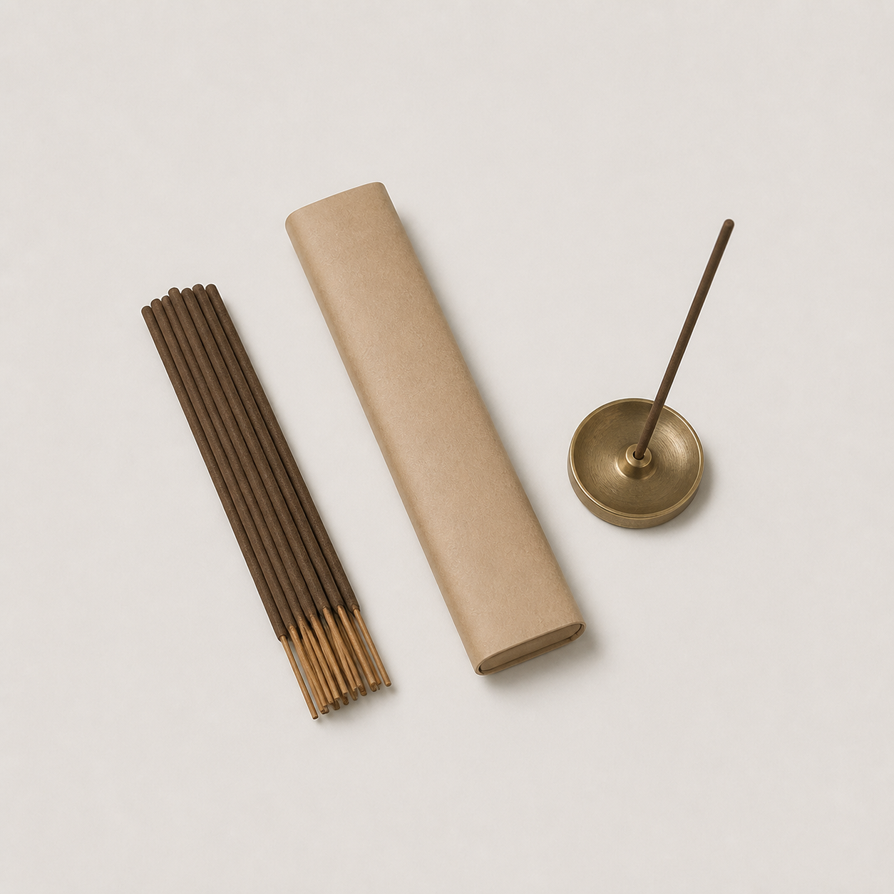 Incense sticks, a plain paper sleeve and a brass incense holder