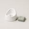 White child's potty training seat with a folded towel